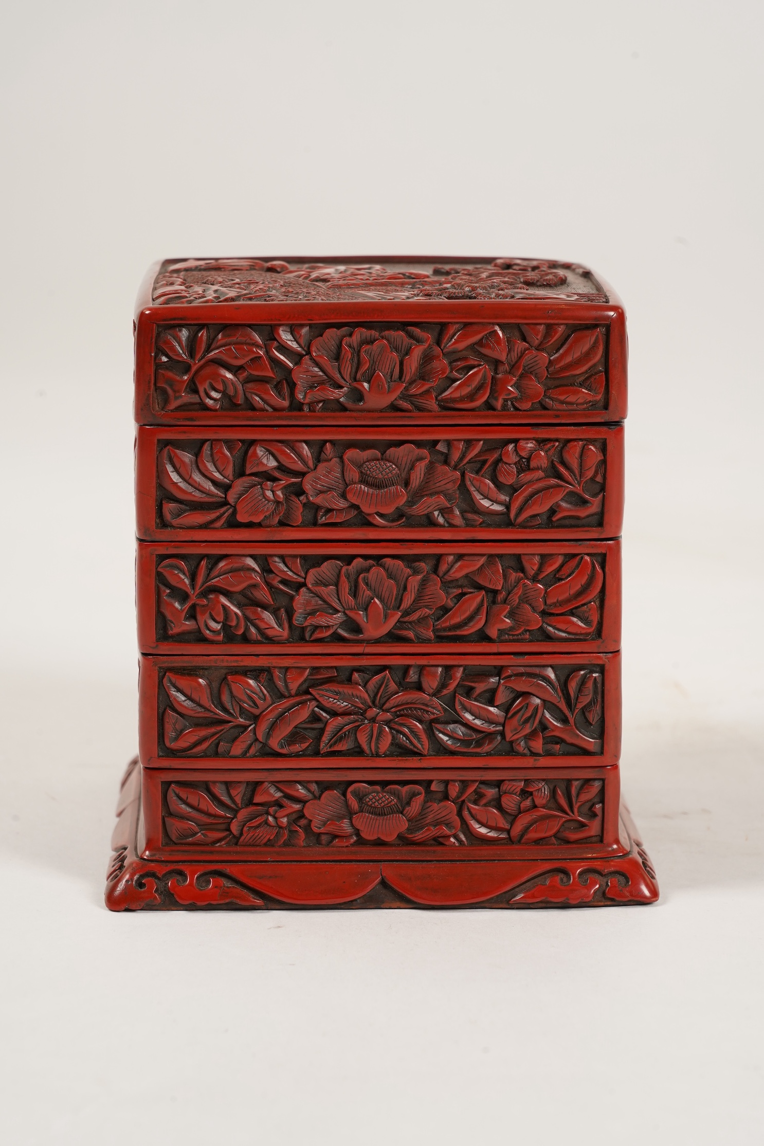 A Chinese Ming cinnabar lacquer four tier box, 15th century